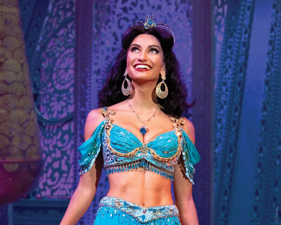 Jasmine in a turquoise costume in the Aladdin production