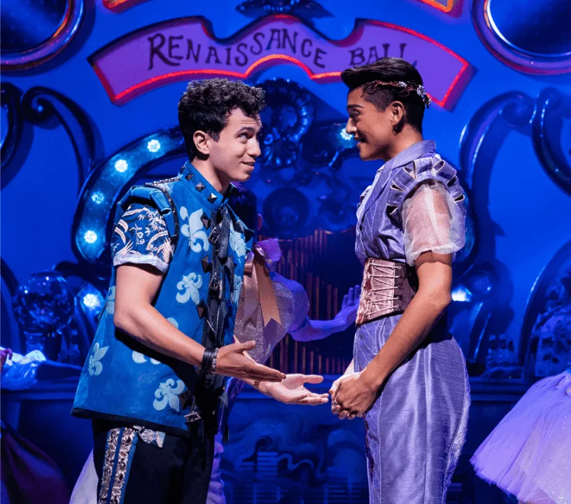 Two & Juliet performers facing each other on a blue-lit set