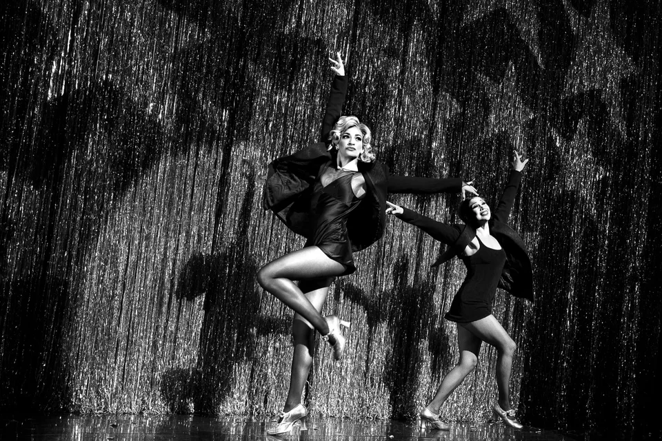 Chicago performers dancing on stage in black costumes