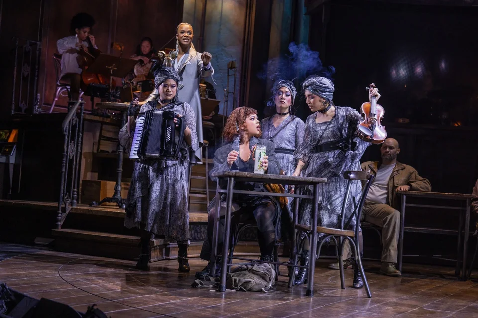 Hadestown cast gathered on the industrial-style stage