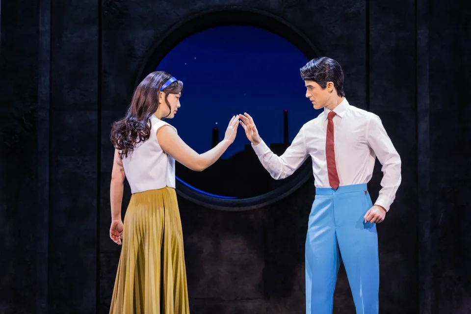 Two Maybe Happy Ending performers reaching towards each other