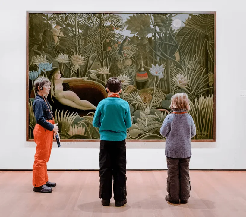 Visitors looking at a lush jungle painting in a MoMA gallery