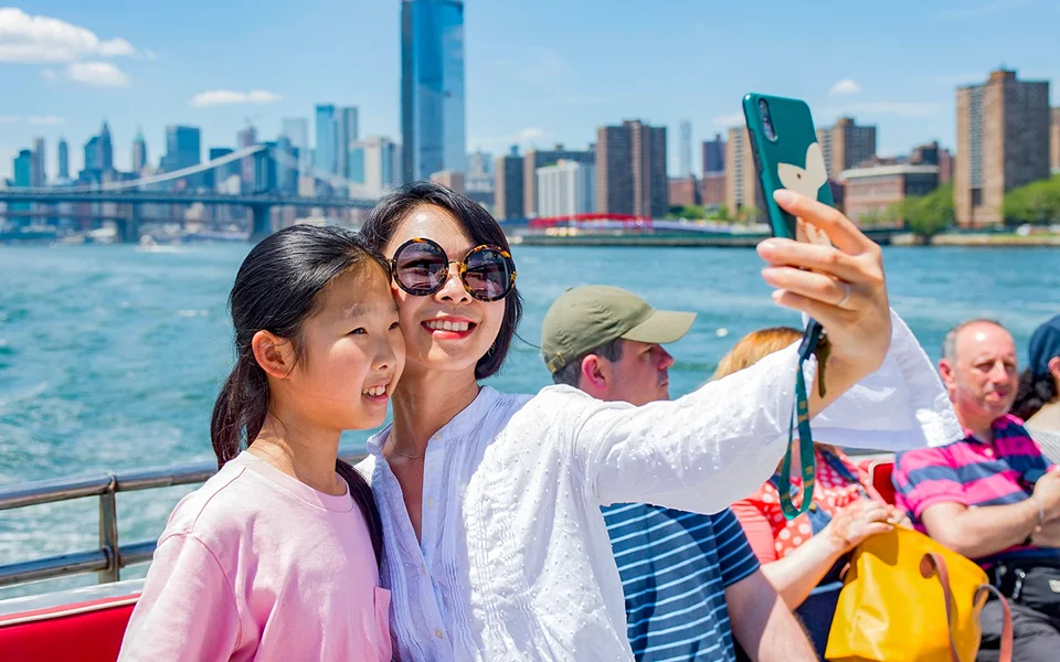 Passengers taking a photograph on a New York sightseeing cruise
