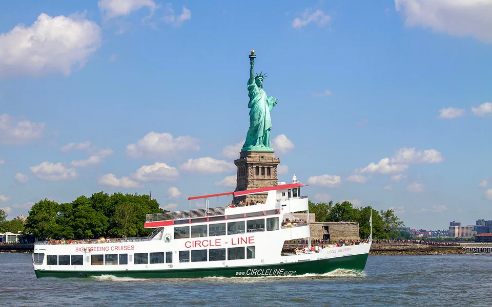 Sightseeing boat passing the Statue of Liberty
