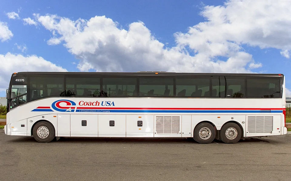Side view of a Coach USA airport coach