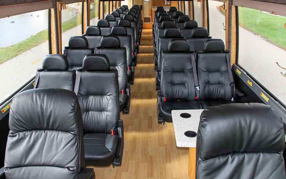 Rows of passenger seats inside an airport coach