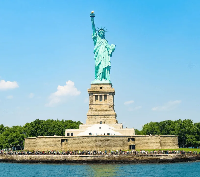 Statue of Liberty above trees on Liberty Island