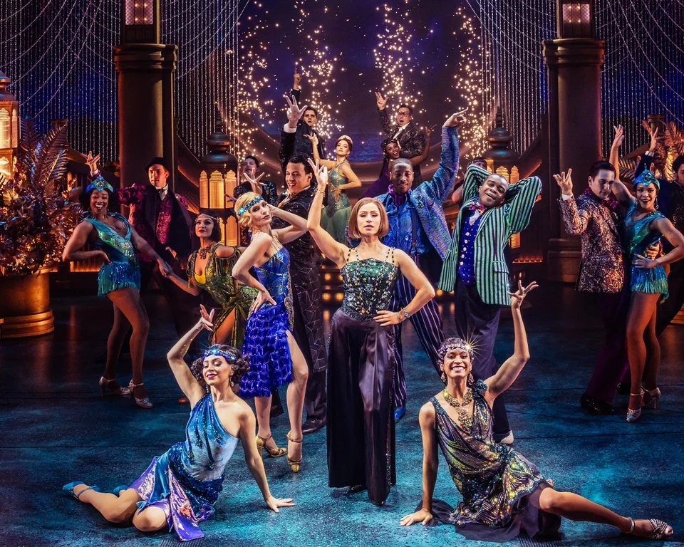 The Great Gatsby ensemble in evening dress on a glittering party set