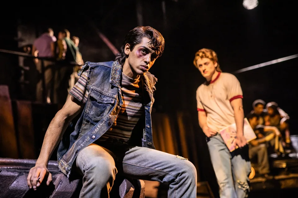 The Outsiders performers on an industrial-style stage set