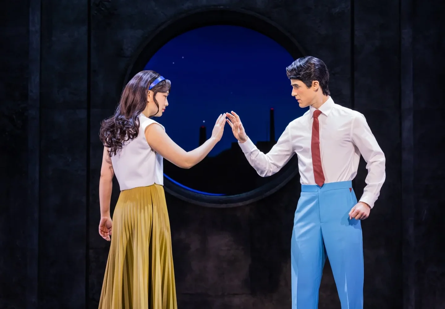 Two Maybe Happy Ending performers reaching towards each other