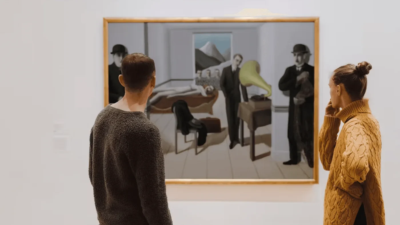 Visitors viewing a framed painting at the Museum of Modern Art