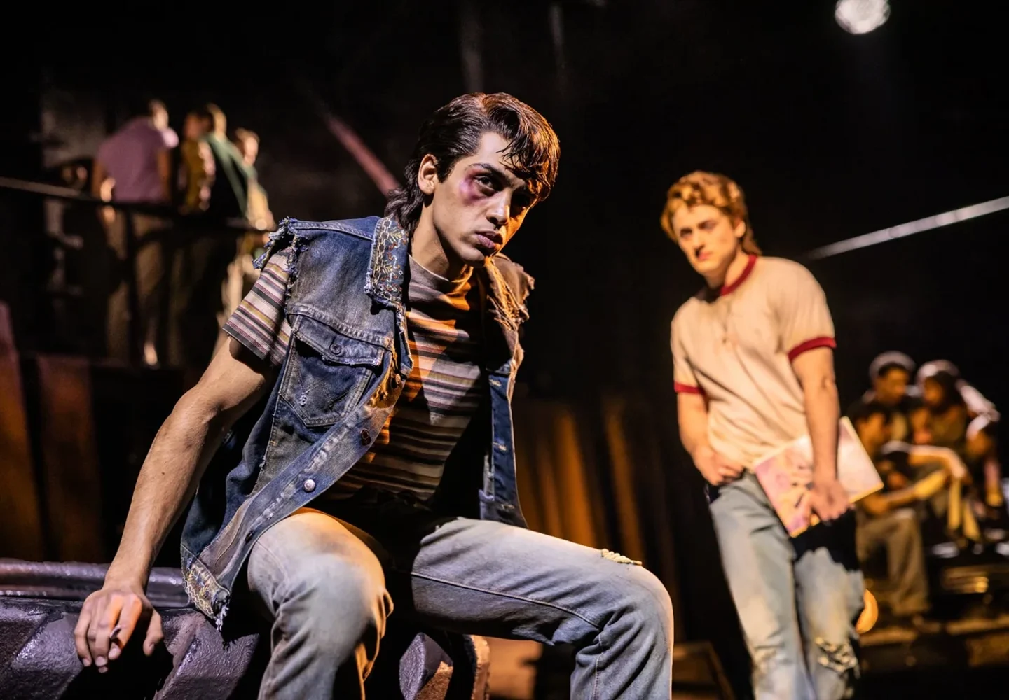 The Outsiders performers on an industrial-style stage set
